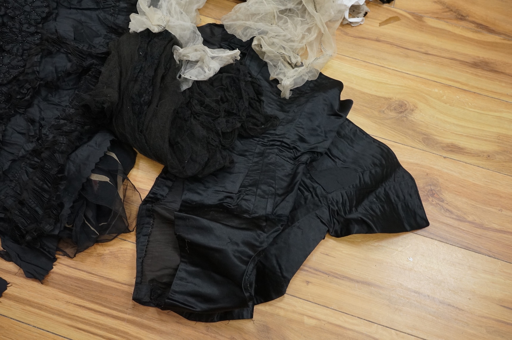 A collection of 19th century fabric and clothing, including a woven Paisley shawl, good for film and TV costume dramas